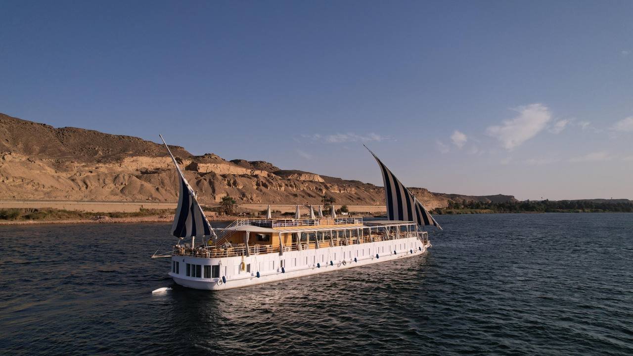 Aerial view of the luxury Dahabiya Soul of the Nile sailing under striped sails on the River Nile in Egypt